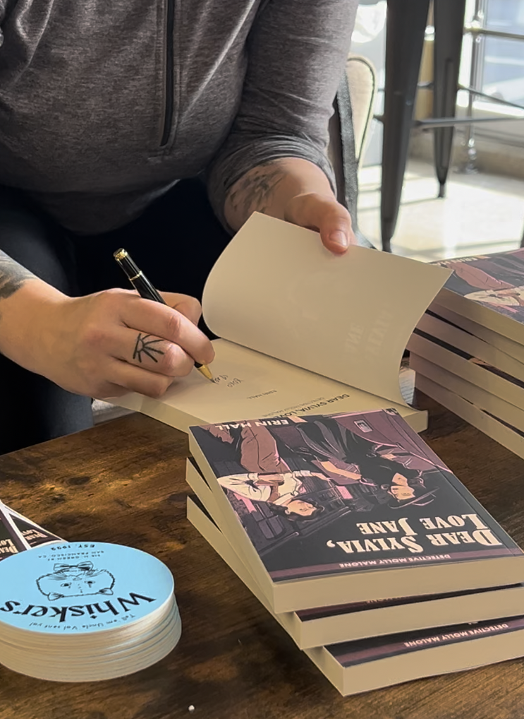 Erin Hall signing copies of Dear Sylvia, Love Jane